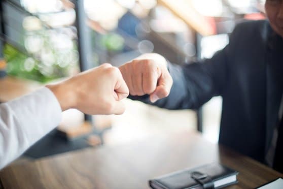 Partners closing a deal with a fist bump